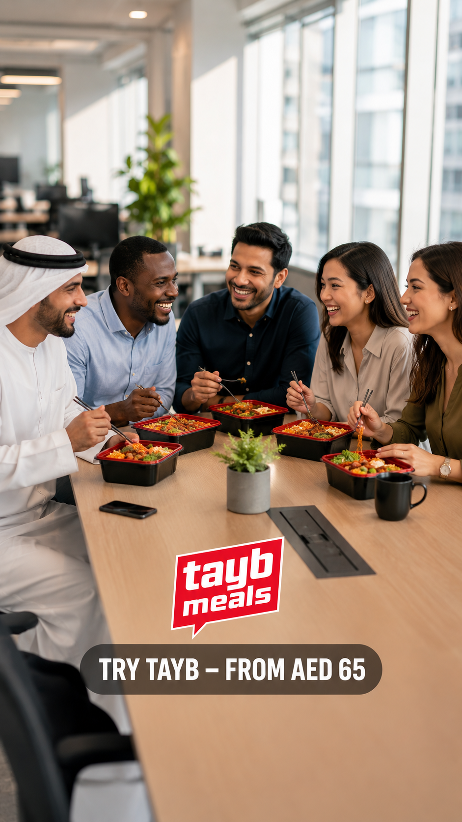 Diverse office employees eating Tayb meals at a desk