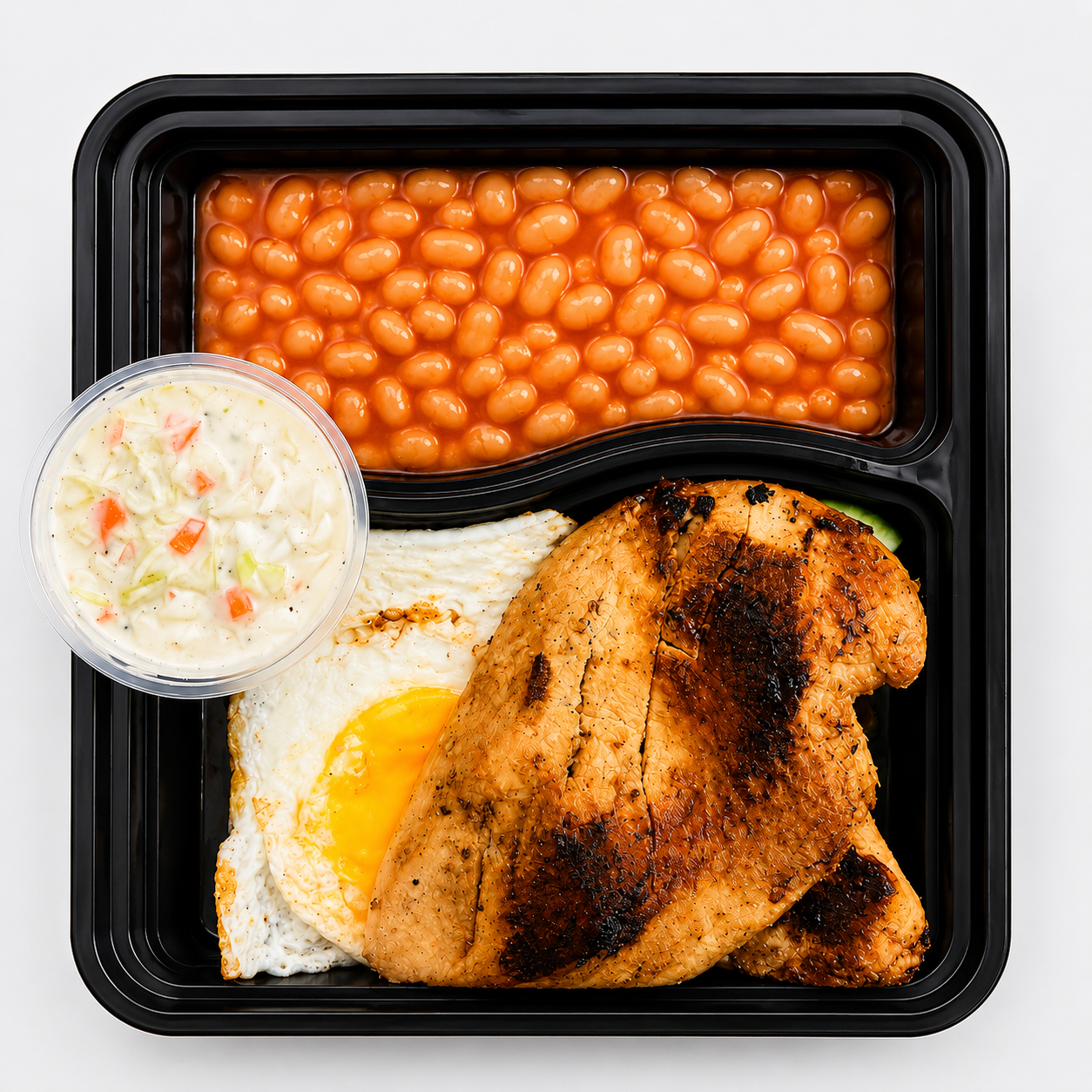 Grilled chicken breast and fried egg meal